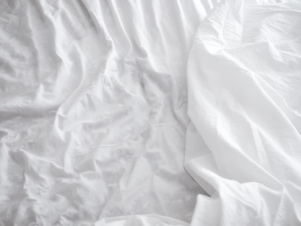 White, crumpled bed sheets.