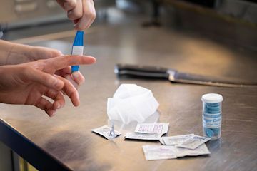 Chef Using First Aid Restaurant First Aid Kit | Alsco
