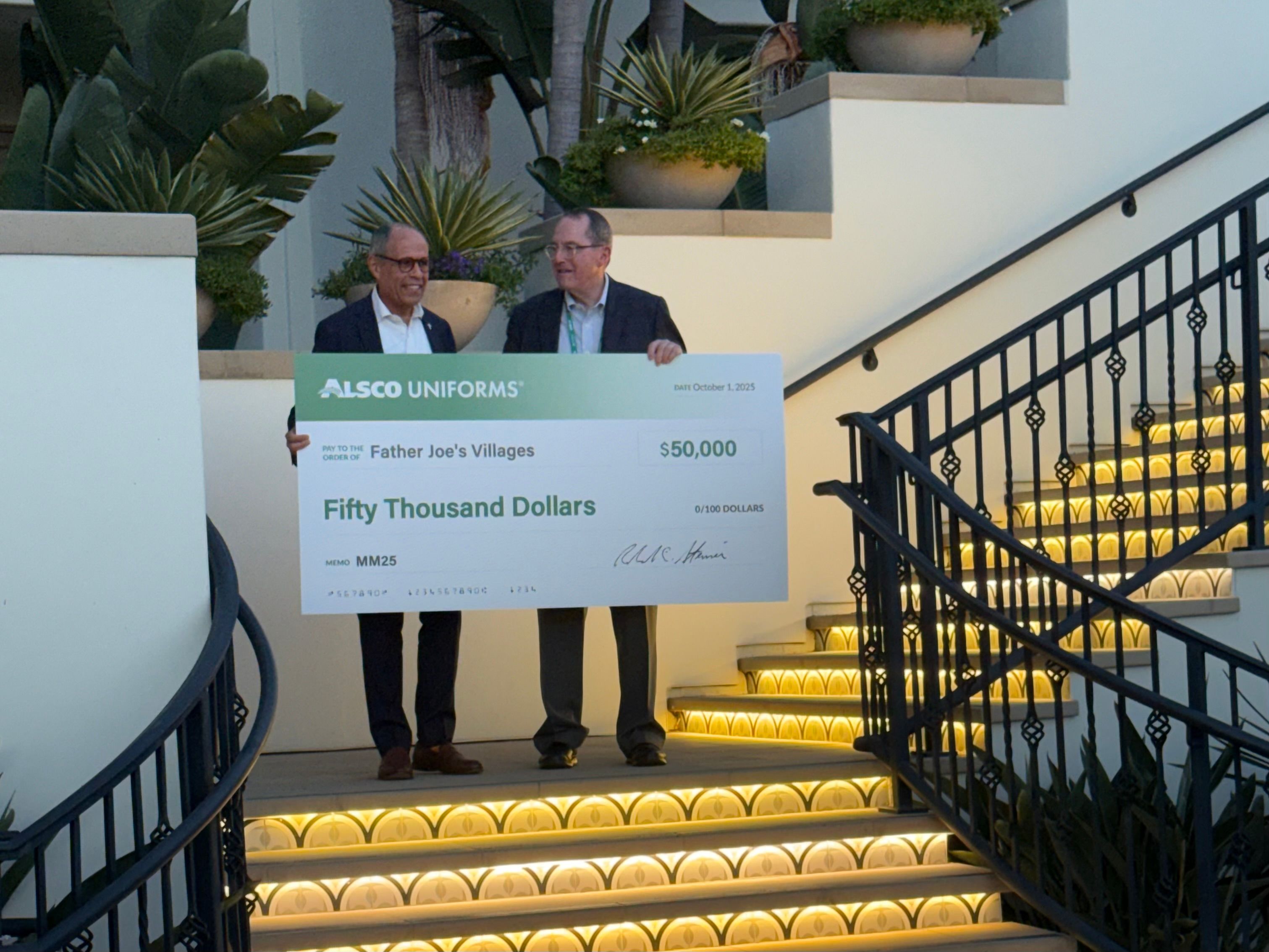 Alsco Uniforms CEO Bob Steiner delivering a $50,000 donation check to Father Joe's Villages CEO Jim Vargas