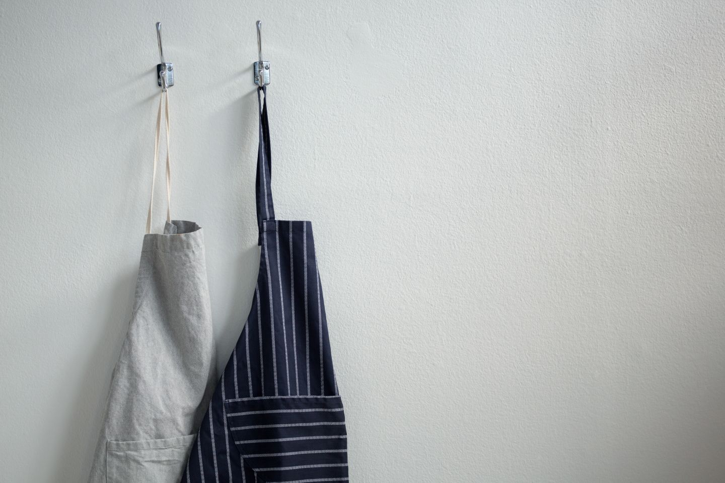 Aprons hanging on hooks