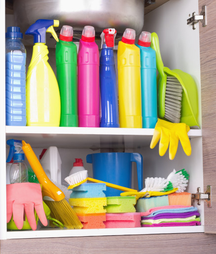 Cleaning supplies in a storage cabinet