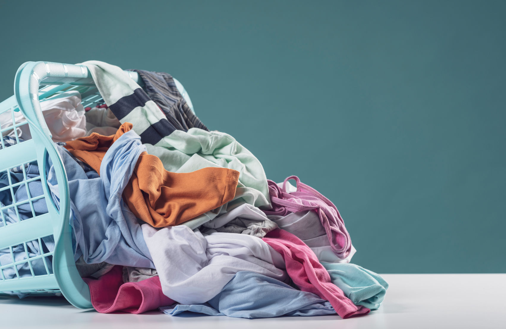 Tipped over laundry basket full of dirty clothes