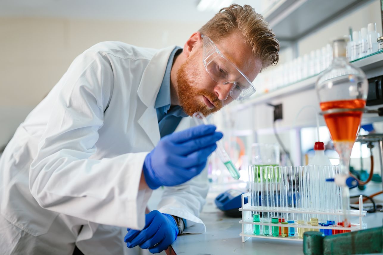 Scientist looking at vials full of fluids