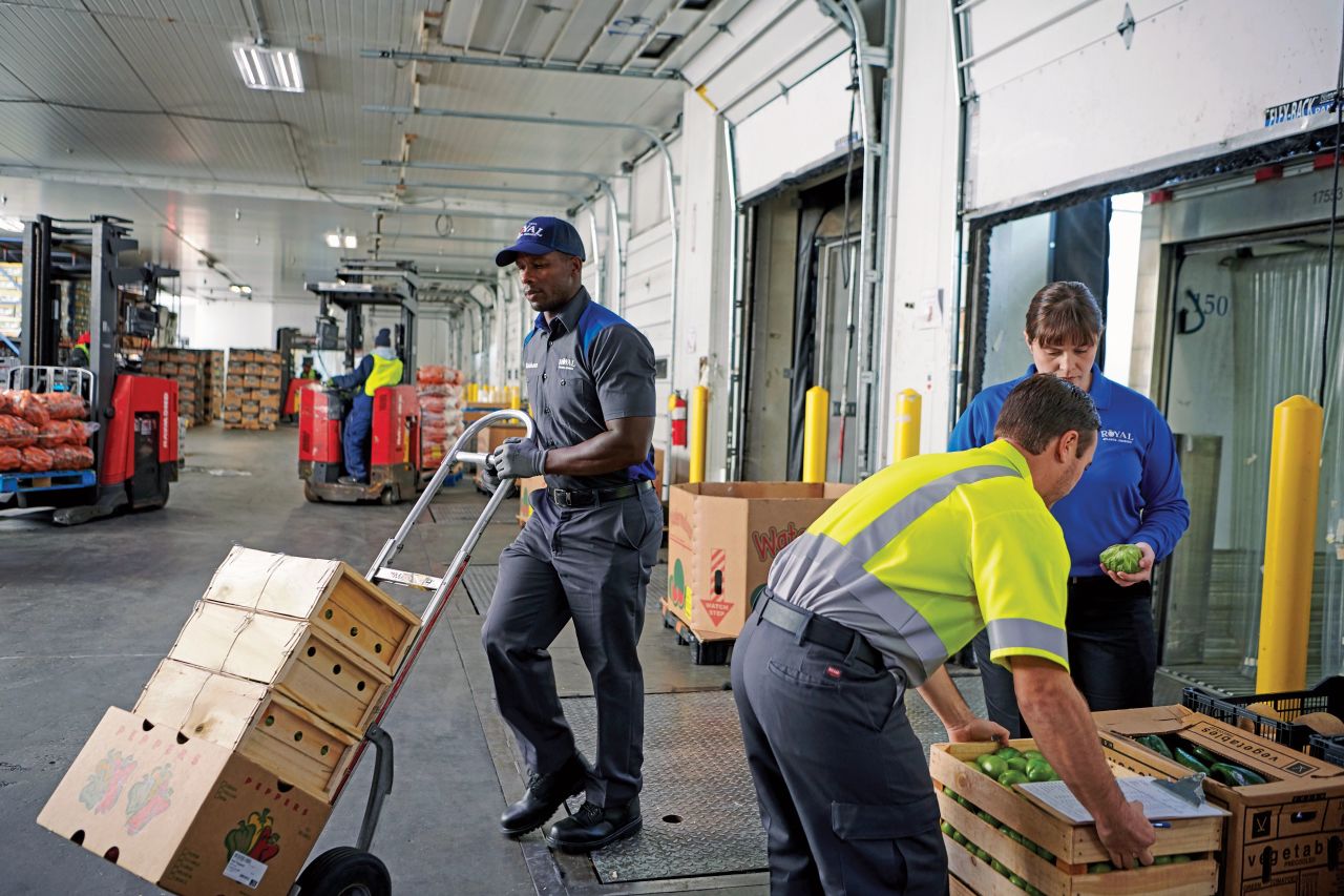 Uniformed workers working in a warehouse.