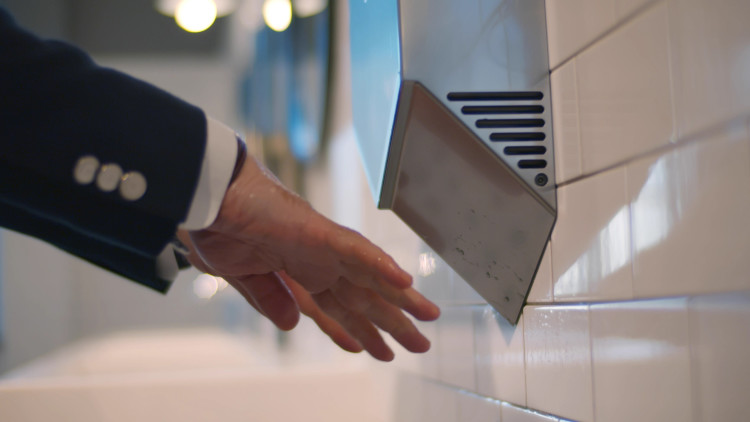 Electric hand dryer in use