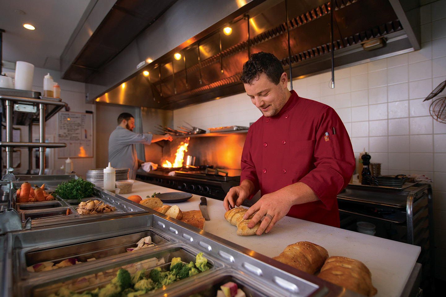 Chef preparing food in a ktchen.