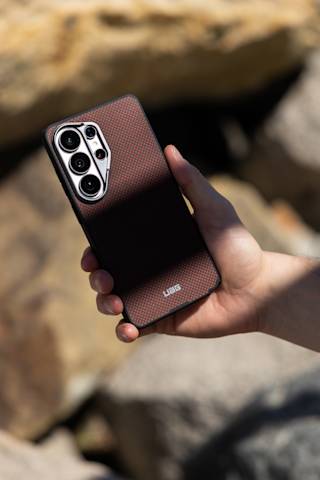 UAG Fibr Armr Galaxy S26 Ultra Case - Limited Edition Galaxy S26 Ultra in Solar Flare/Charcoal lifestyle view
