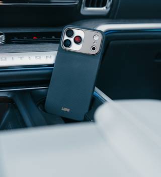 UAG Fibr Armr iPhone 17 Pro Max Case iPhone 17 Pro Max in Kevlar Graphite/Bronze lifestyle view