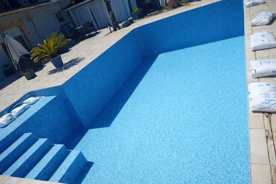 Pose liner bleu texturé sur grand bassin en L avec escalier roman - Gironde