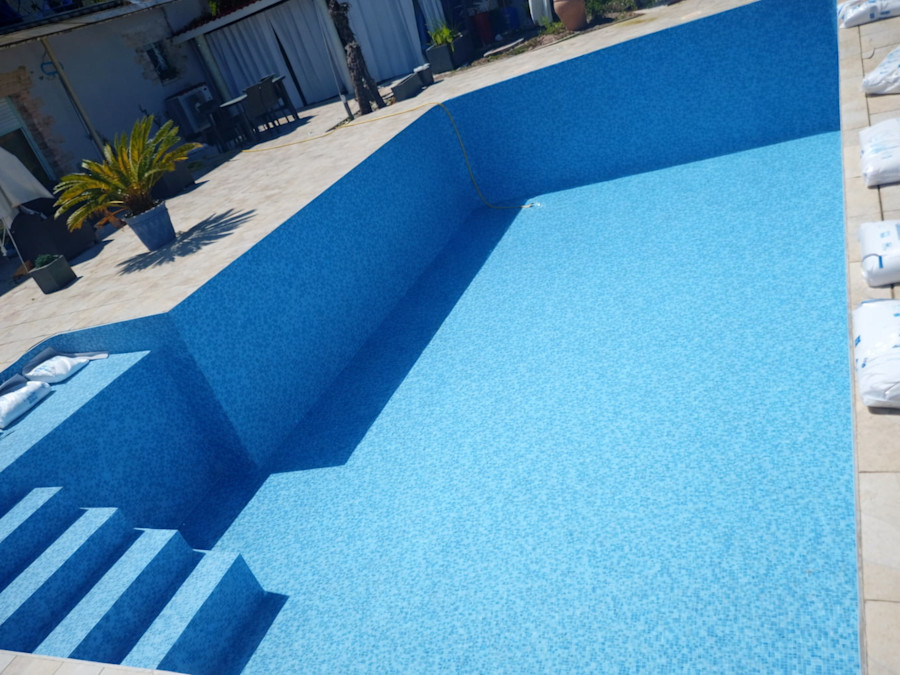 Pose liner bleu texturé sur grand bassin en L avec escalier roman - Gironde