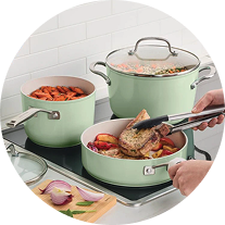 KitchenAid® pots and pans on a cooktop