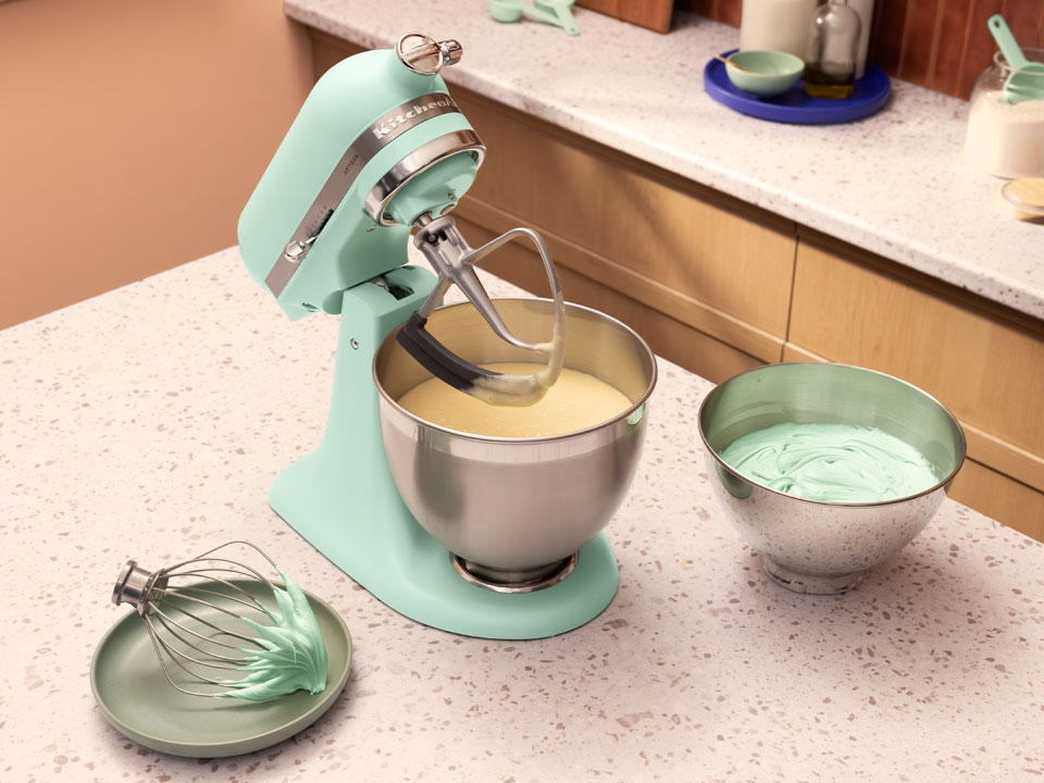 A Spearmint stand mixer on a countertop.