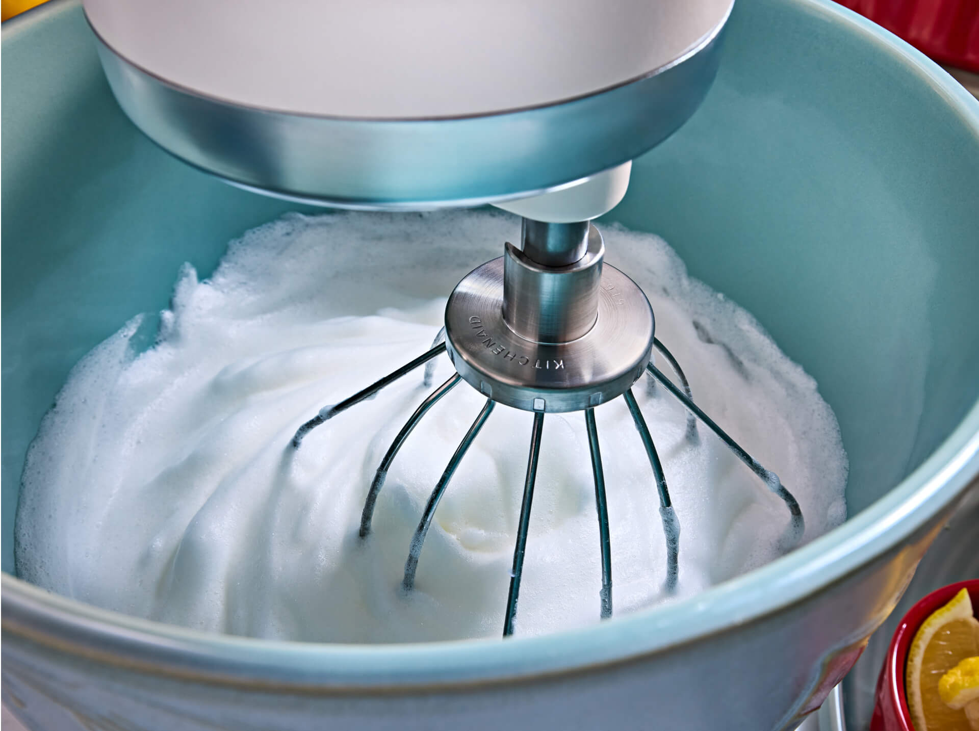 A KitchenAid<sup>®</sup> stand mixer with a wire whip attachment