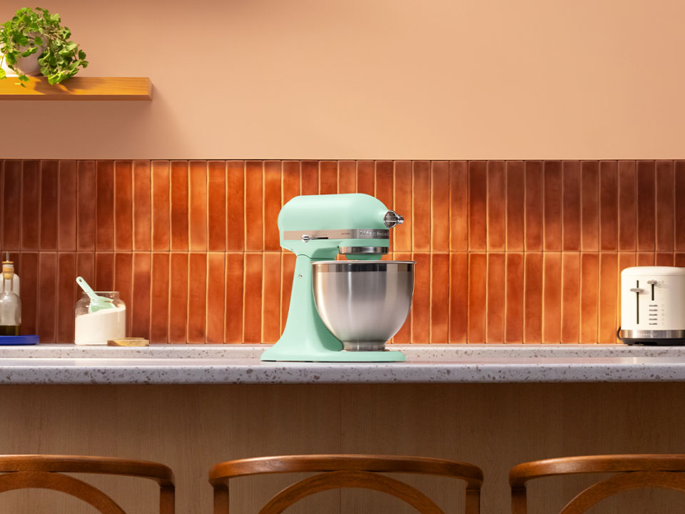 A Spearmint stand mixer on a countertop.