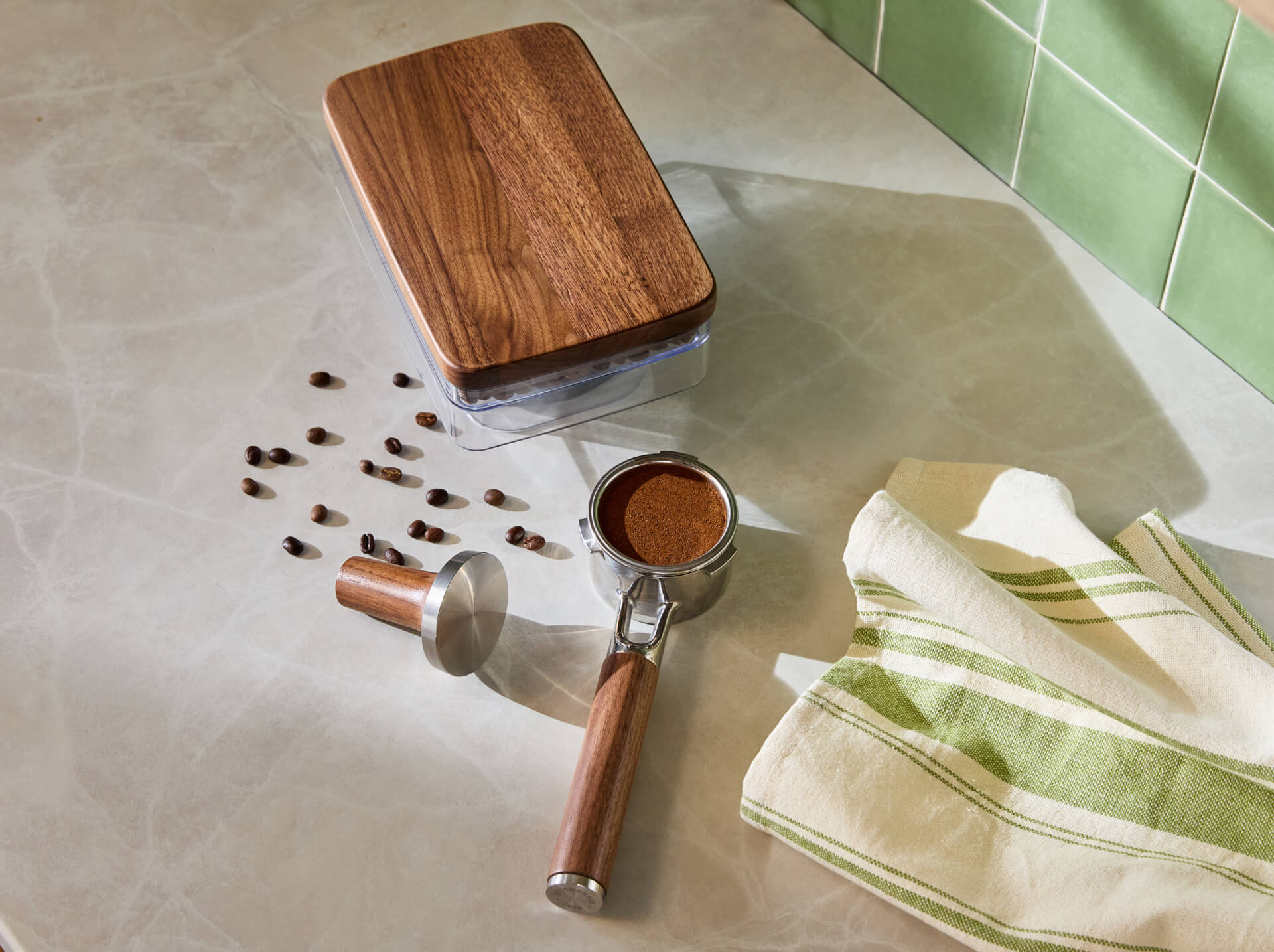 The bean hopper and portafilter and tamper set in walnut.