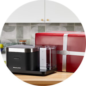 A KitchenAid® grain and rice maker and red gift box