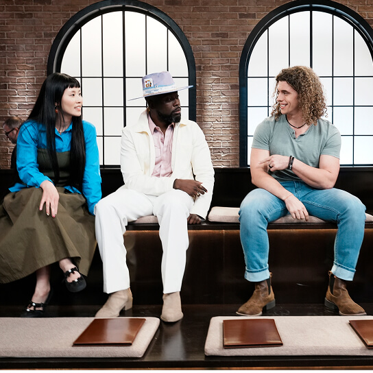 Three people sitting on a bench