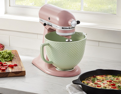 A pink KitchenAid® stand mixer with a green bowl