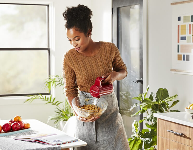 A person mixing a bowl of cookie dough.