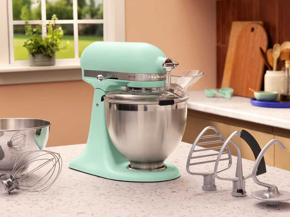 A Spearmint stand mixer on a countertop.