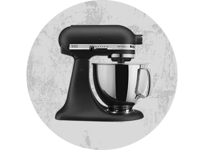 A Cast Iron Black stand mixer on a monochromatic crinkled background.
