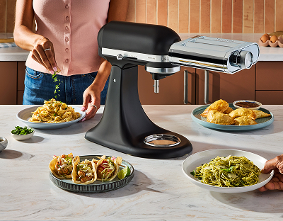 A person using the KitchenAid® pasta maker attachment