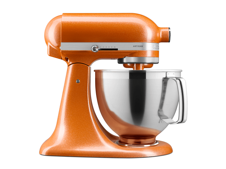 A Tangerine Twinkle stand mixer on a green background, with glitter and tangerine colors around it.