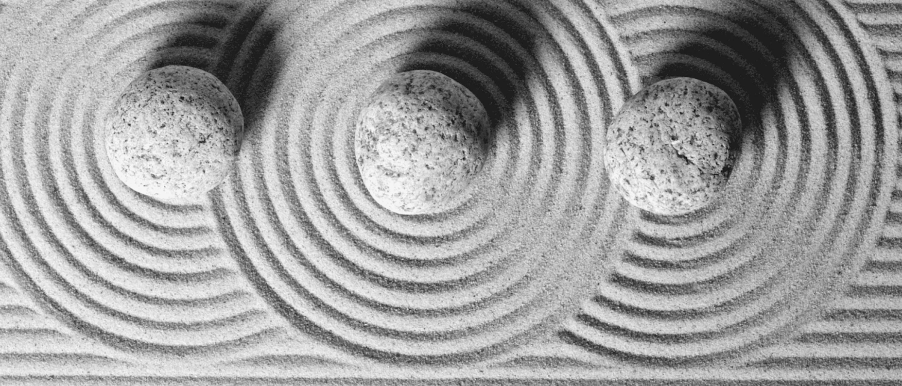 Schwarz-Weiß-Bild japanischer Kreise im Sand.