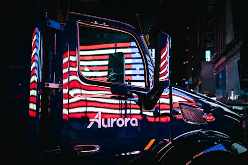 Aurora truck at night with reflection of the US flag