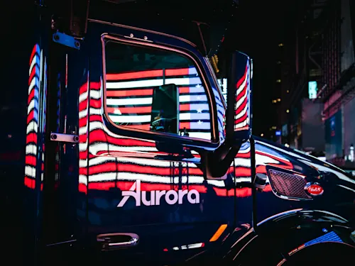 Aurora truck at night with reflection of the US flag