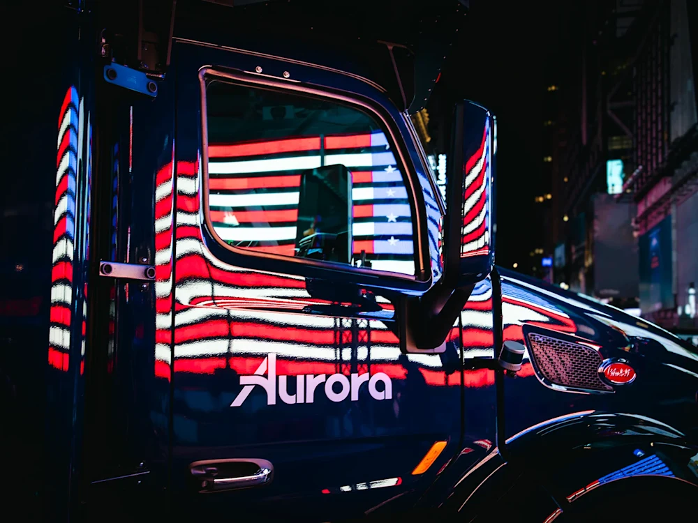 Aurora truck at night with reflection of the US flag