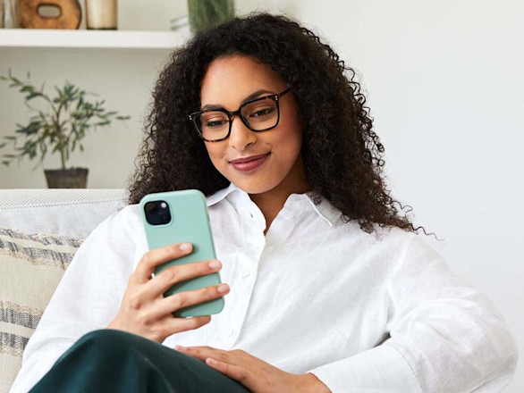 A women wear glasses while using her phone