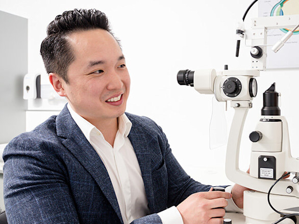 An optometrist is treating a patient