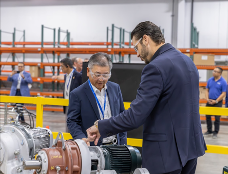 Tony Barlett (right), vice president of operations of Sumitomo Drive Technologies, highlights the North American manufacturing of the Cyclo 6000 gear reducer components at Sumitomo Drive Technologies' grand opening in Glendale Heights, Illinois.