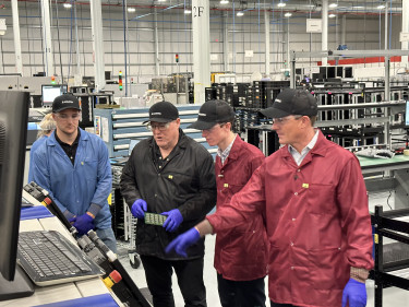 Two father and son manufacturing duos at the Magna facility. At left are manufacturing engineer Alex Cunningham and General Manager John Cunningham; at right are Max and Travis Egan, co-hosts of 