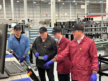 Two father and son manufacturing duos at the Magna facility. At left are manufacturing engineer Alex Cunningham and General Manager John Cunningham; at right are Max and Travis Egan, co-hosts of