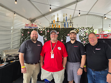 Distributors are part of a local community’s fabric, such as when Cardinal Machinery and builder Smart Machine Tool sponsored the entry of pitmaster and customer Ron Monmaney Jr. (second from left), owner Mitchell and Son Inc., at the 2025 World Championship Barbecue Cooking Contest.  
