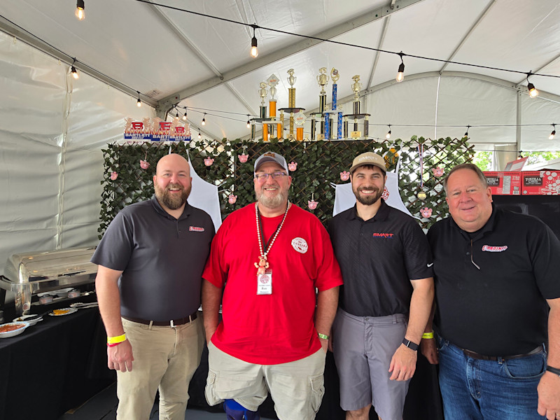 Distributors are part of a local community’s fabric, such as when Cardinal Machinery and builder Smart Machine Tool sponsored the entry of pitmaster and customer Ron Monmaney Jr. (second from left), owner Mitchell and Son Inc., at the 2025 World Championship Barbecue Cooking Contest.  