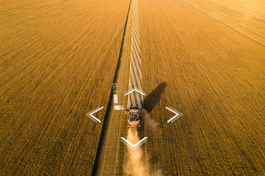 autonomous farming equipment harvesting a field