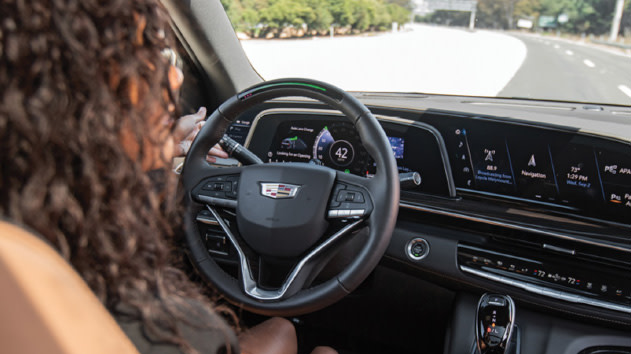 Woman driving a GM car with super cruise that utilizes Trimble RTX technology