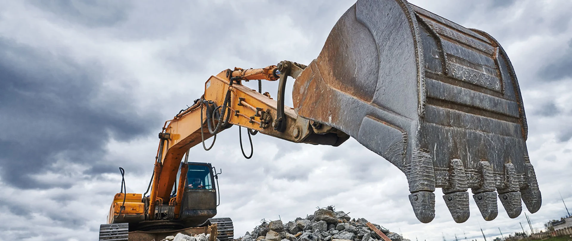 Excavator moving debris at a construction site