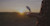 man flying drone over a field