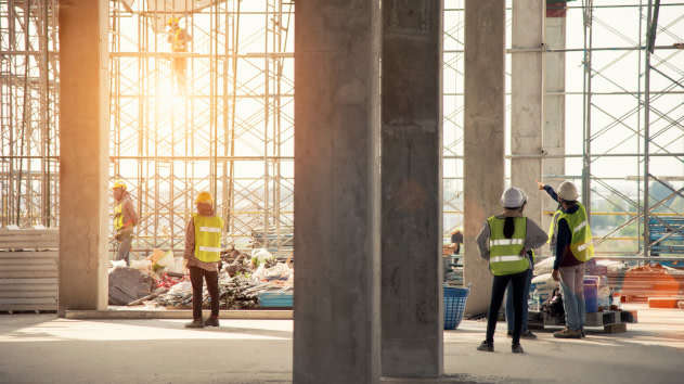 Workers measuring around a construction site