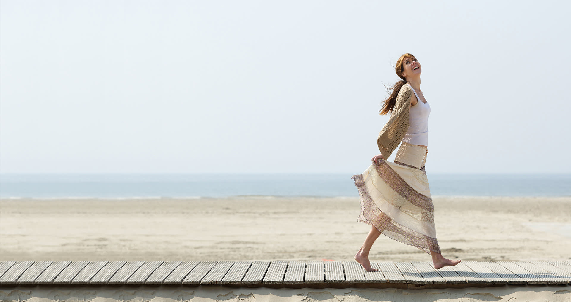woman-walking-on-deck-near-beach-i-screen