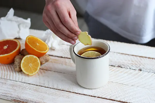 A cup of tea with lemon and ginger.