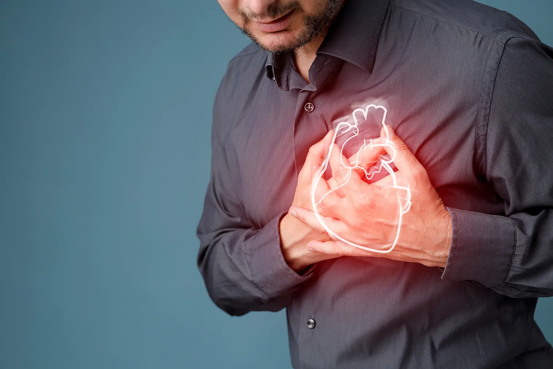 Man holding his hands to his heart and an animated outline of a heart is glowing where his heart would be.