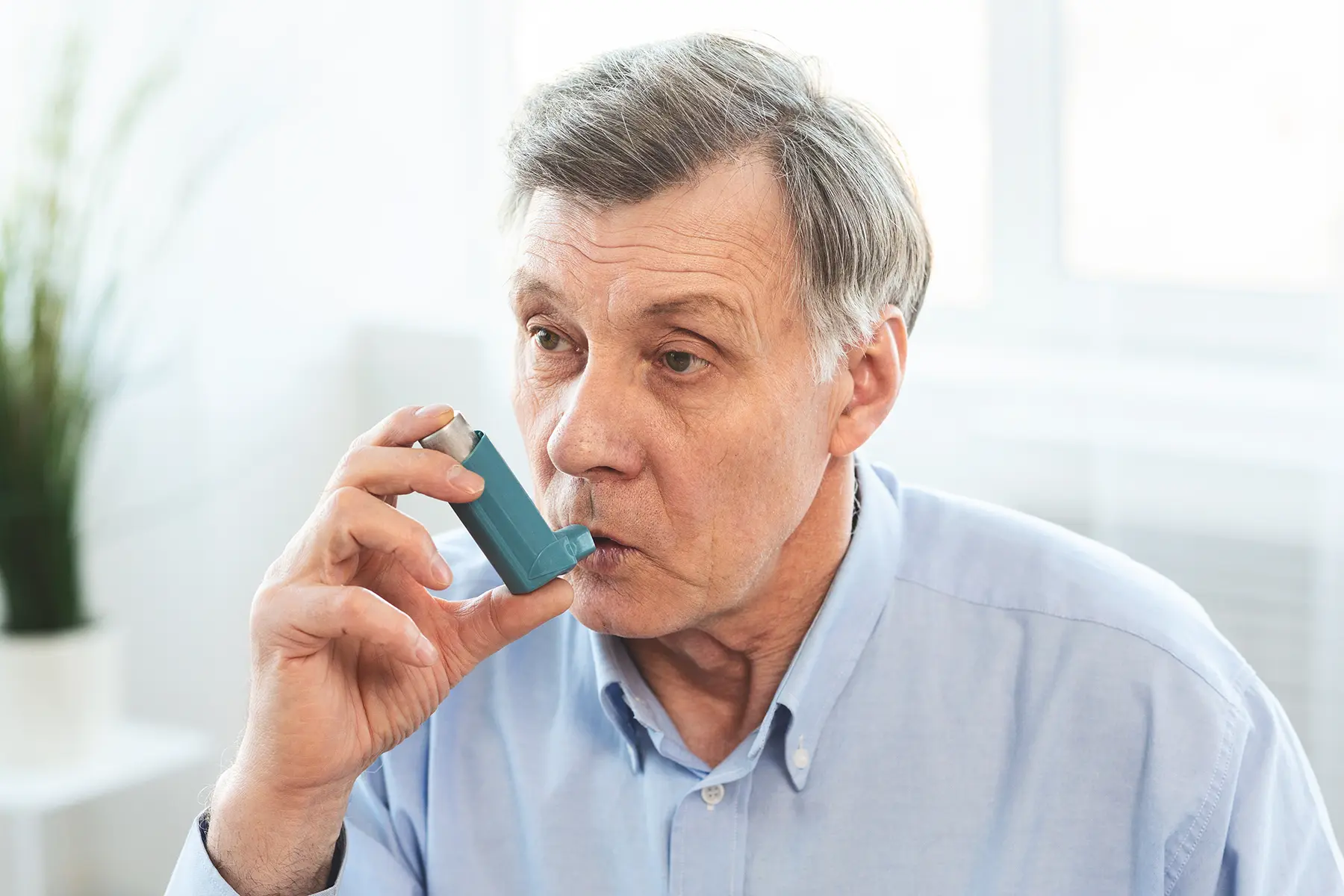 A man using an inhaler