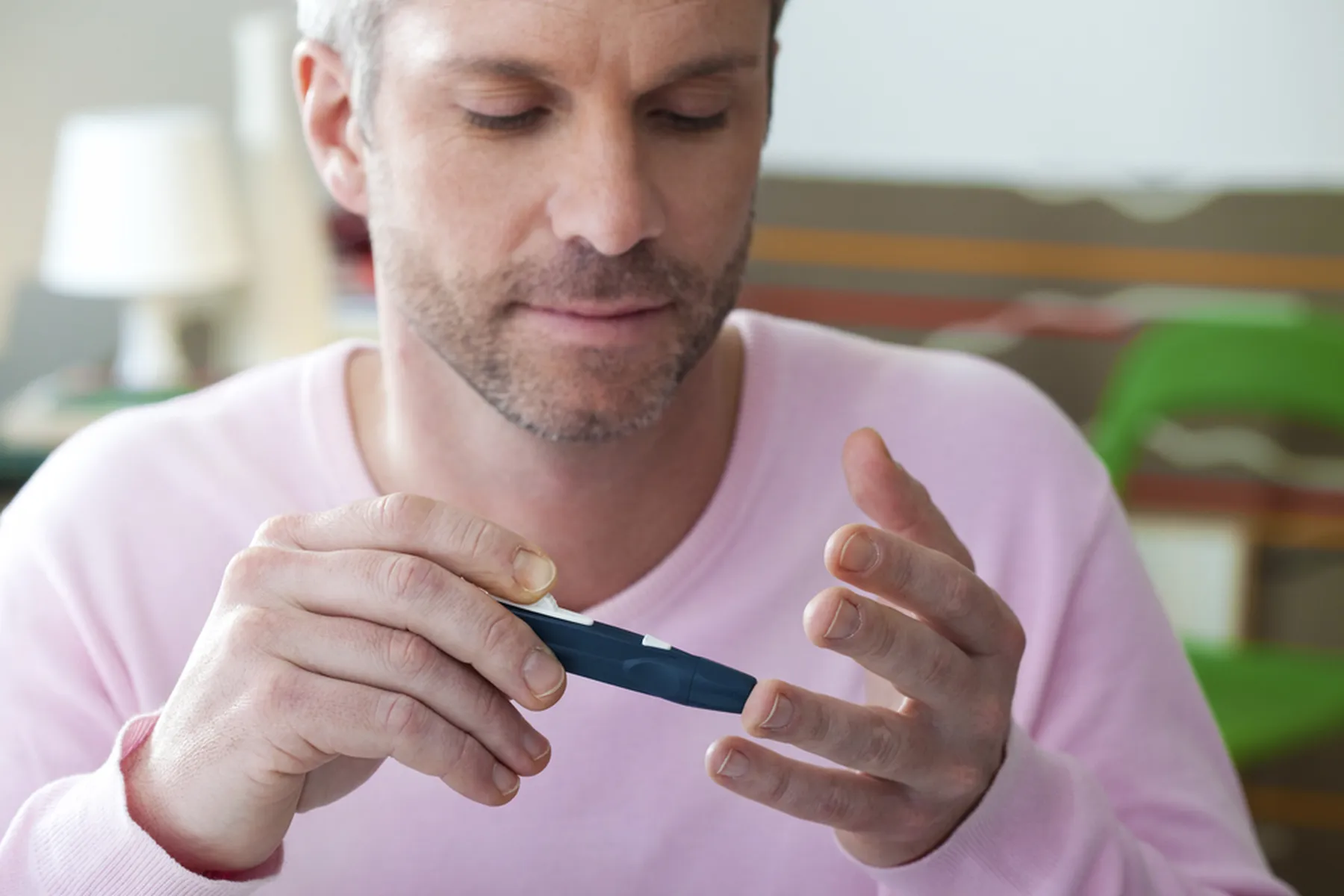 A man test his blood sugar levels with a diabetes pen test.