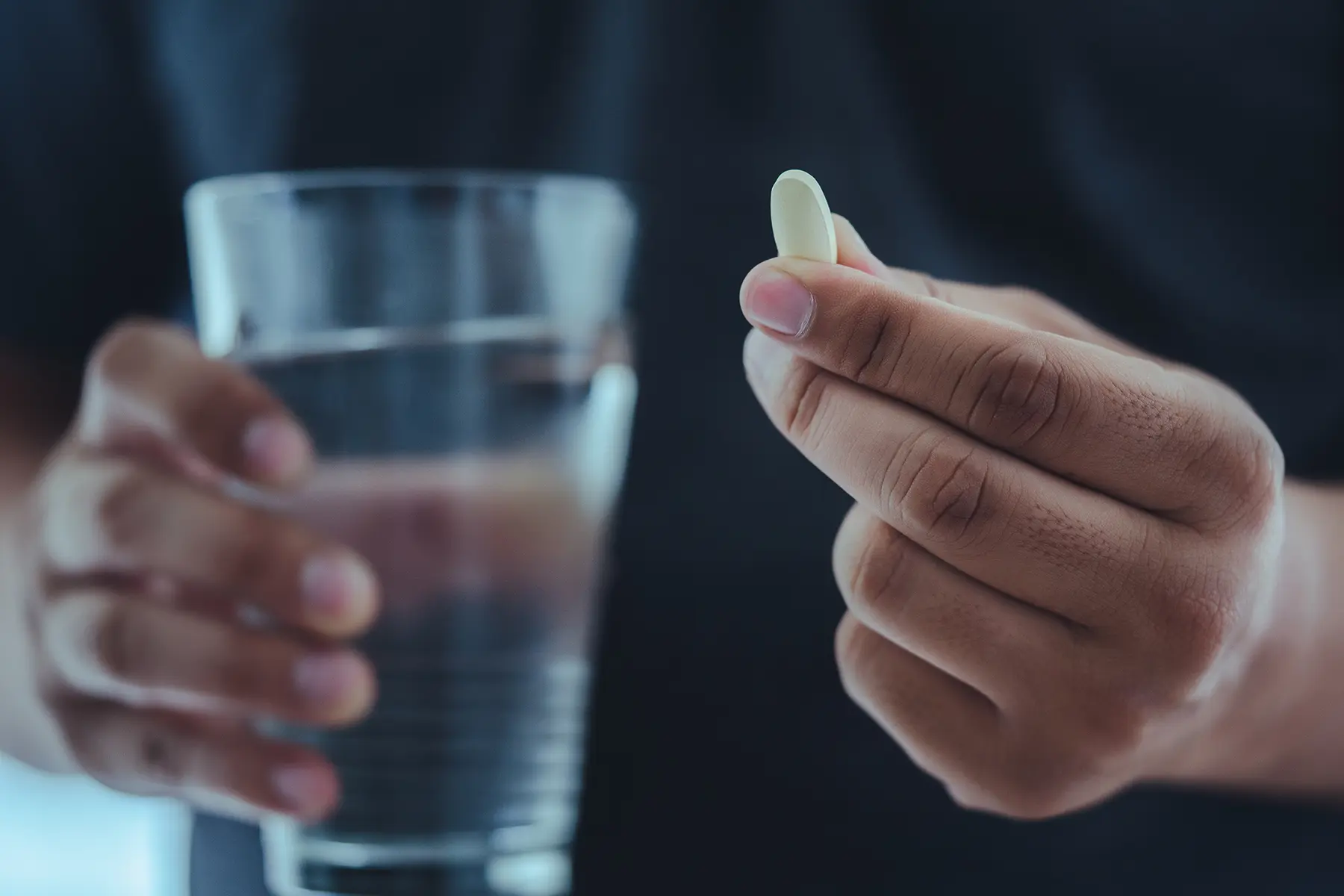 A glass of water and medicine