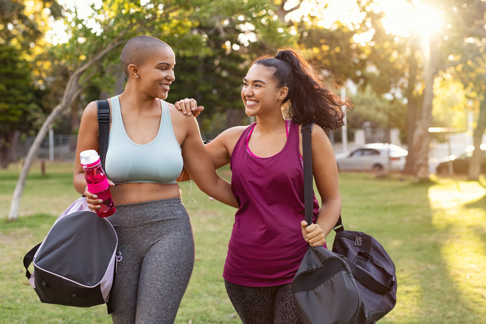 Two women smile after working out.